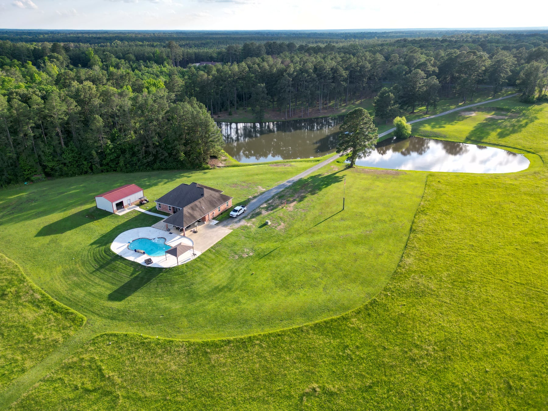 Country home with a pool and ponds